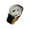 Close-up of stainless steel wristwatch with hand-painted floral dial inspired by tropical plants and black leather strap